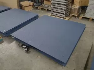 Pallet goods loaded on floor pallet scales for weight measurement in warehouse
