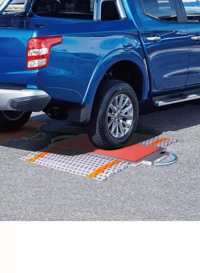 Truck weighing on portable vehicle weighing scales at outdoor site